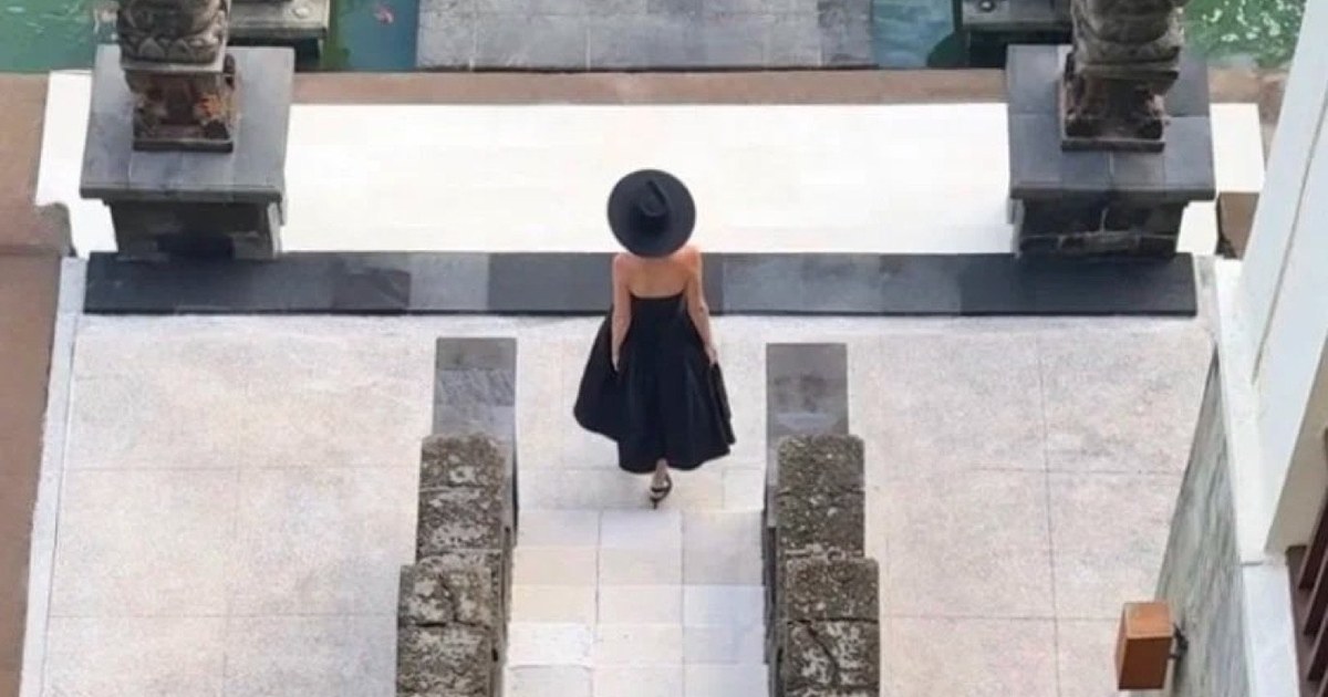 Looking down on the stone entrance steps, lotus bowls and guardian statues at The Legian Seminyak